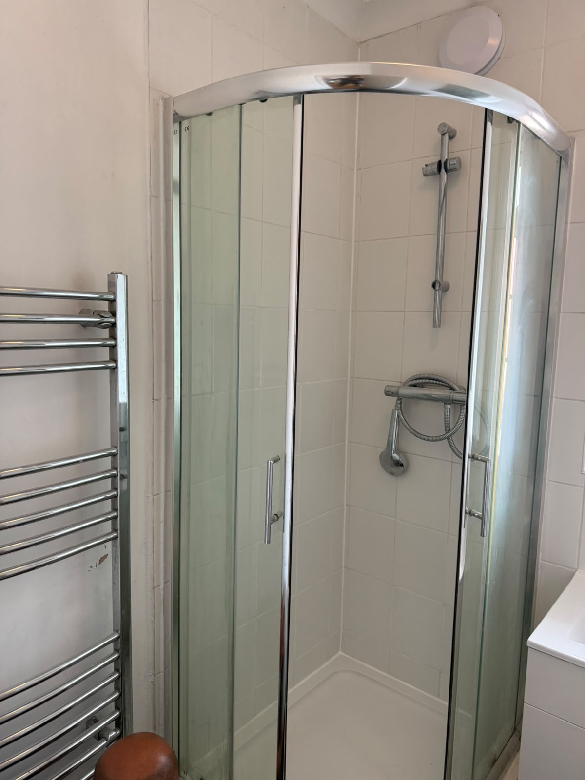New quadrant shower enclosure and chrome towel radiator fitted by MJ Mani