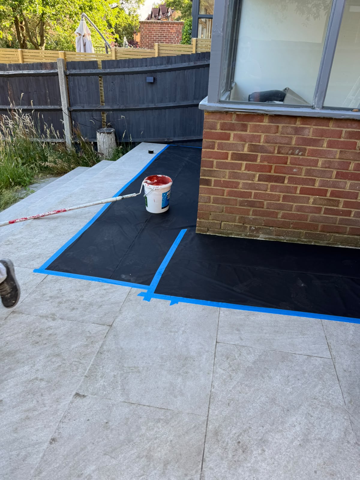 Travertine patio protected during exterior redecoration